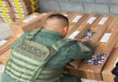 Oficial de la Policía de Fronteras inspeccionando el cargamento de álbumes y postales del Mundial decomisado por contrabando en Golfito.